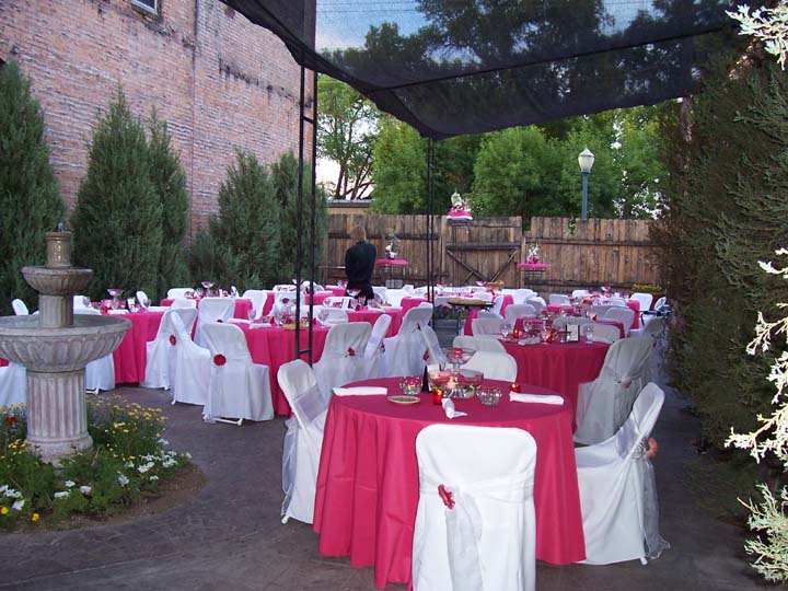 Bistro garden wedding with full chair covers and fuchsia linens