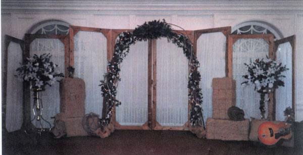 flowers run thru to create a western arch to frame the couple Artifical